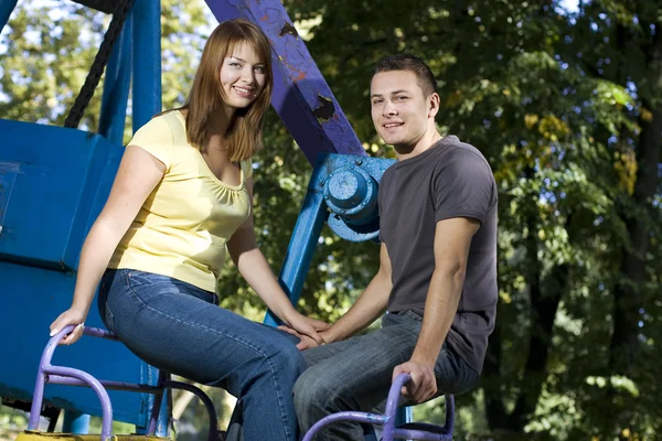 Young couple on the carousel — Stock Photo, Image