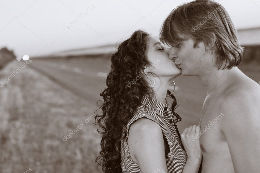 Couple kissing at the edge of road