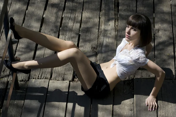 Dziewczyna siedzi na drewnianej podłodze — Zdjęcie stockowe