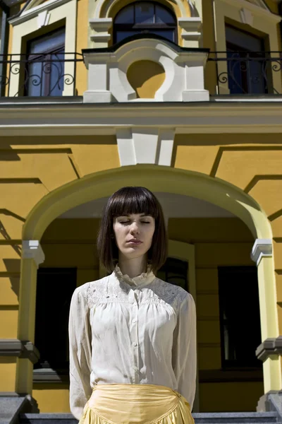 Красивая девушка стоит перед домом — стоковое фото