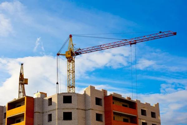 Two cranes and house construction Royalty Free Stock Images