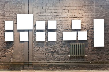 Empty frames on brown brick wall clipart