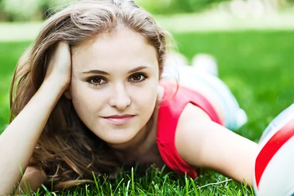 Attractive girl lay on grass Royalty Free Stock Photos