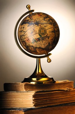 Antique globe on books clipart