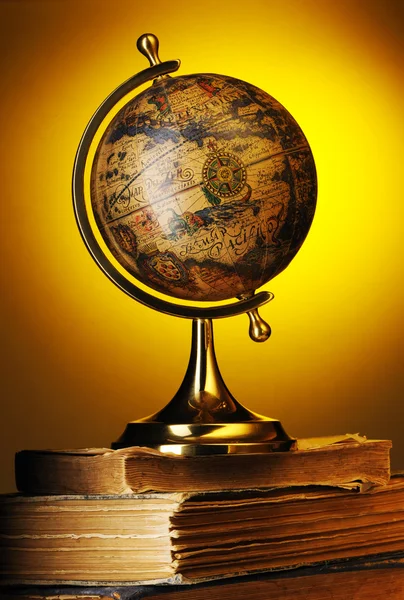 stock image Antique globe on books