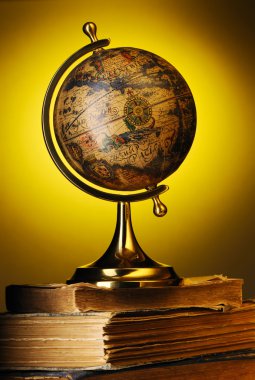 Antique globe on books clipart