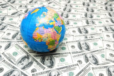 Globe over many dollars clipart