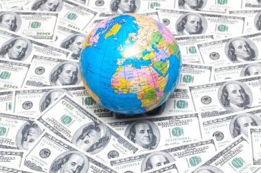 Globe over many american dollars clipart