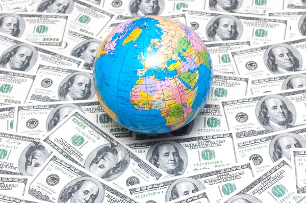 stock image Globe over many american dollars