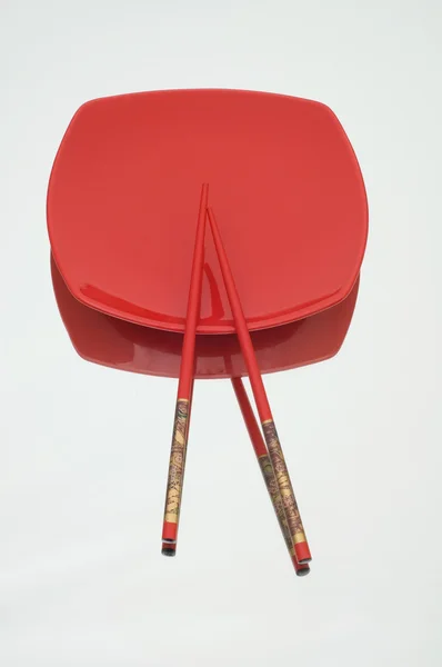 stock image Red plate and chopsticks