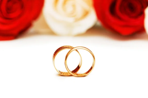 Wedding rings and roses isolated Stock Image