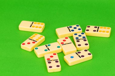 Lots of dominoes on the green clipart