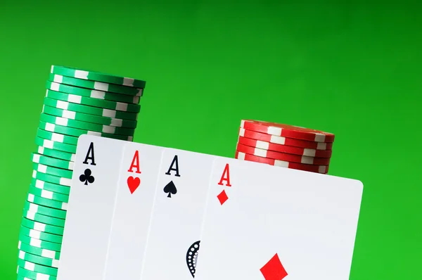 Casino chips and cards against green — Stock Photo, Image