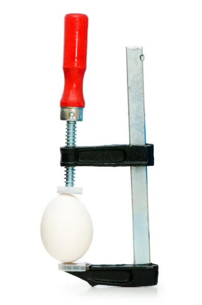 Strength concept with egg and clamp — Stock Photo, Image