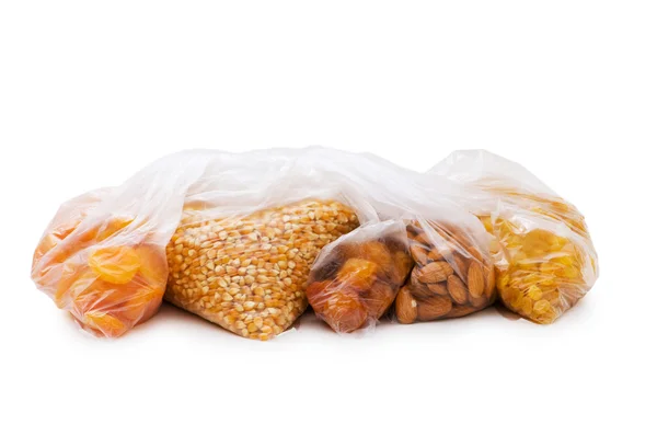 Various dry fruits in the bags on white — Stock Photo, Image