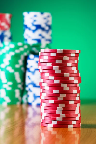 Stack of casino chips against gradient — Stock Photo, Image