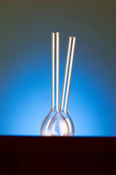 Glass retorts against blue gradient — Stock Photo, Image