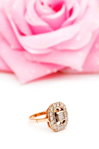 Złoty pierścień i róża w tle — Zdjęcie stockowe