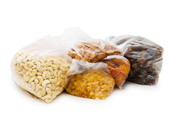 Various dry fruits in the bags on white — Stock Photo, Image