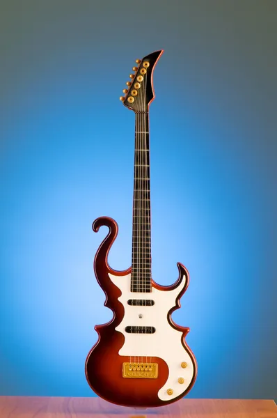 Wood guitar against gradient — Stock Photo, Image