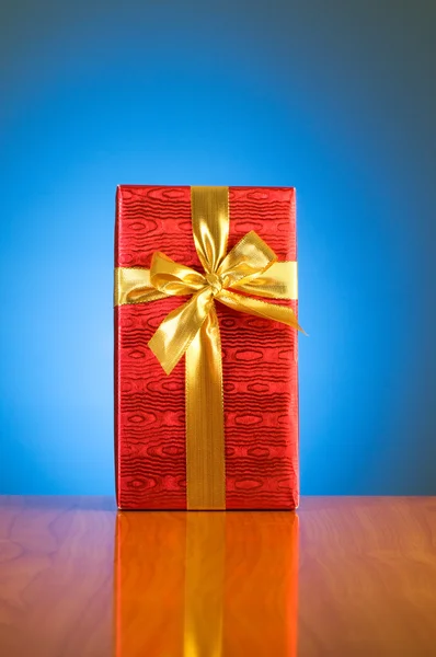 Gift box against gradient — Stock Photo, Image