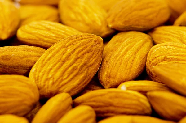 Fresh almonds arranged on the white — Stock Photo, Image