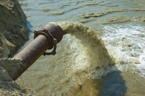 Dirty water flows from a pipe. — Stock Photo © kotomiti #2065701