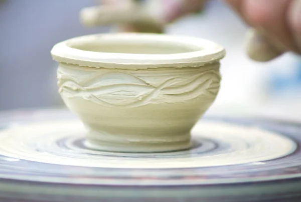 Potters hands creating a clay masterpiece at the turning wheel. — Stock Photo, Image