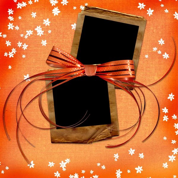 Orange card with old slides and bow — Stock Photo, Image