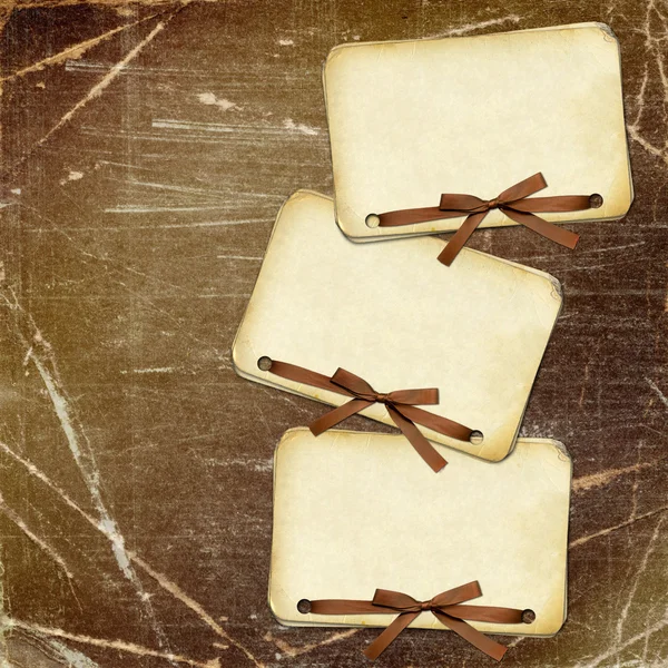 Grunge papers with bow on dark — Stock Photo, Image