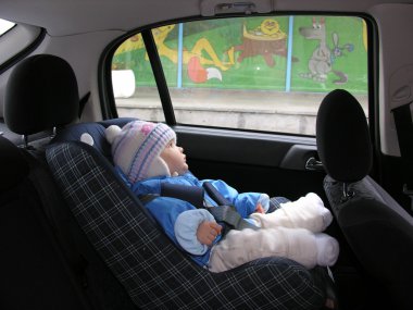 Baby in car with dreams in window clipart