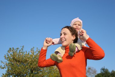 Baby on mother shoulders clipart