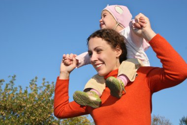 Baby on mother shoulders clipart