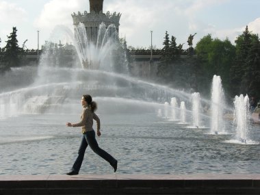 Running girl at fountain clipart