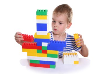 Child with toy blocks clipart