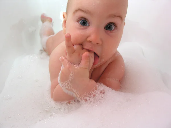 Baby in bath. hand in mouth — Stock Photo, Image