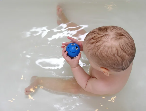 Baby with smile toy in bath — Stock Photo, Image