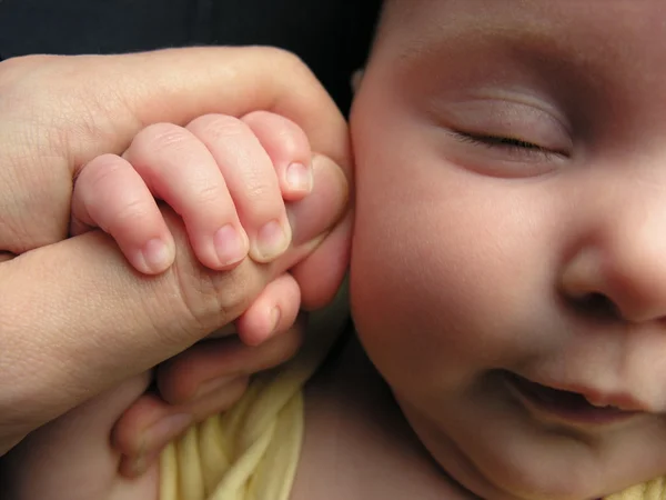 Baby sleep with father's finger — Stock Photo, Image