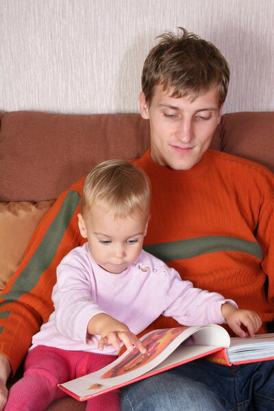 Father with baby and book