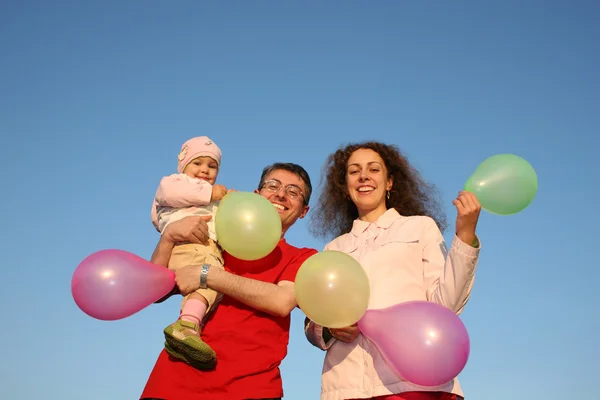 Family with baby and balloons — Stock Photo, Image