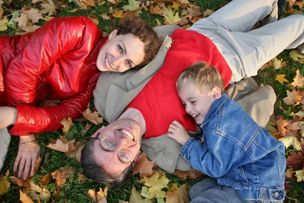 Family on autumn leaves — Stock Photo, Image