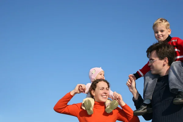 Family with children on shoulders — Stock Photo, Image