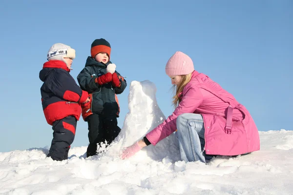 Mother with children play on snow — Stock Photo, Image