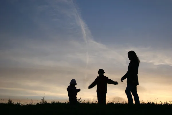 Silhouette mother with children — Stock Photo, Image