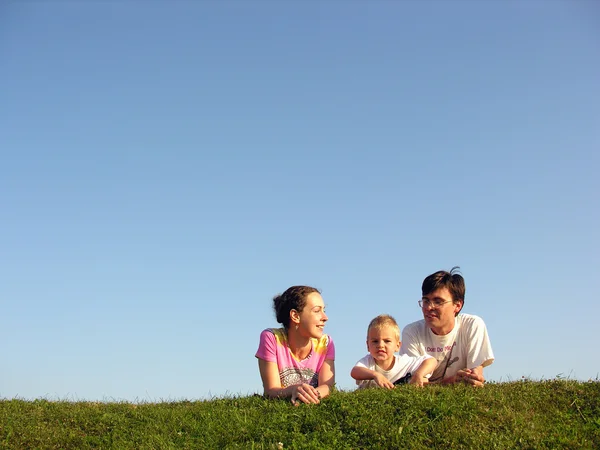 Семья на траве под небом — стоковое фото