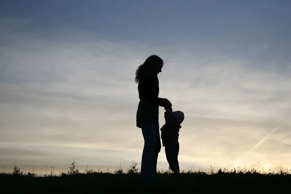Silhouette mother with baby — Stock Photo, Image