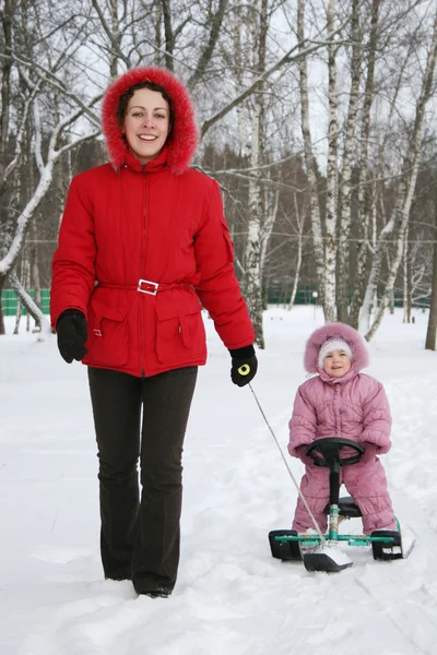 Mother with baby on sled — Stock Photo, Image