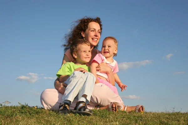 Мать с детьми на траве — стоковое фото