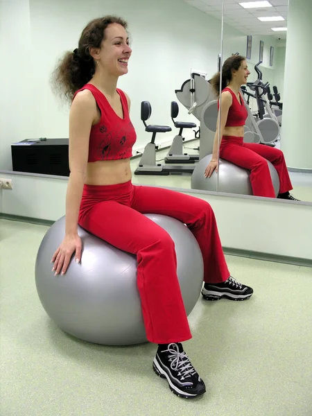 Woman on ball in healthclub — Stock Photo, Image