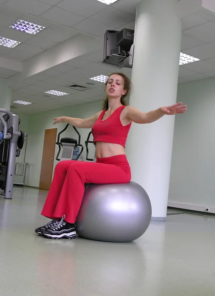 Girl in health club on rubber ball 2 — Stock Photo, Image
